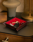 Leather valet tray, dark tan with red, lifestyle