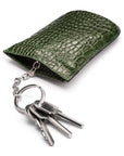 Leather key case with squeeze spring opening, green croc, open