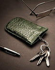 Leather key case with squeeze spring opening, green croc, lifestyle