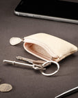 Miniature leather coin purse with key chain, ivory, lifestyle