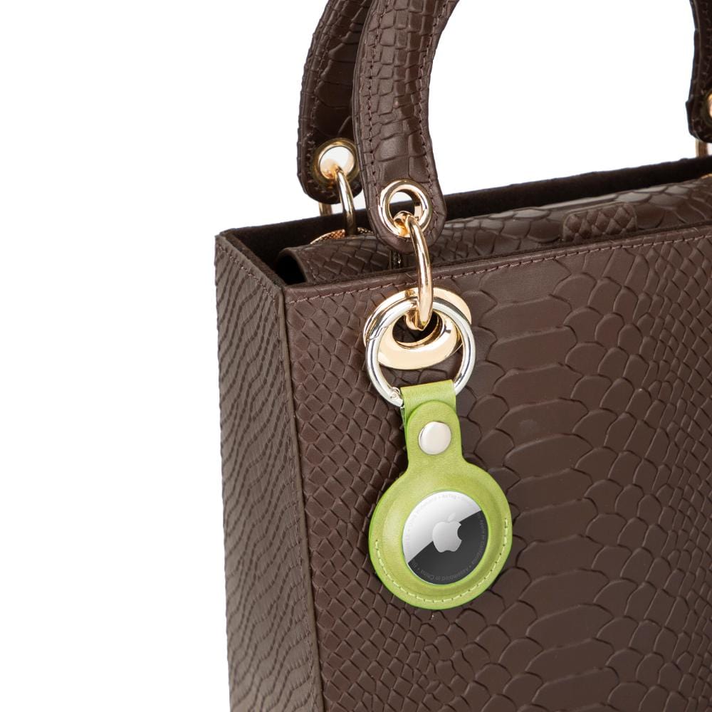 Leather air tag holder, lime green, on a bag