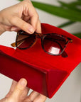 Triangular leather glasses case, burnished red, lifestyle view