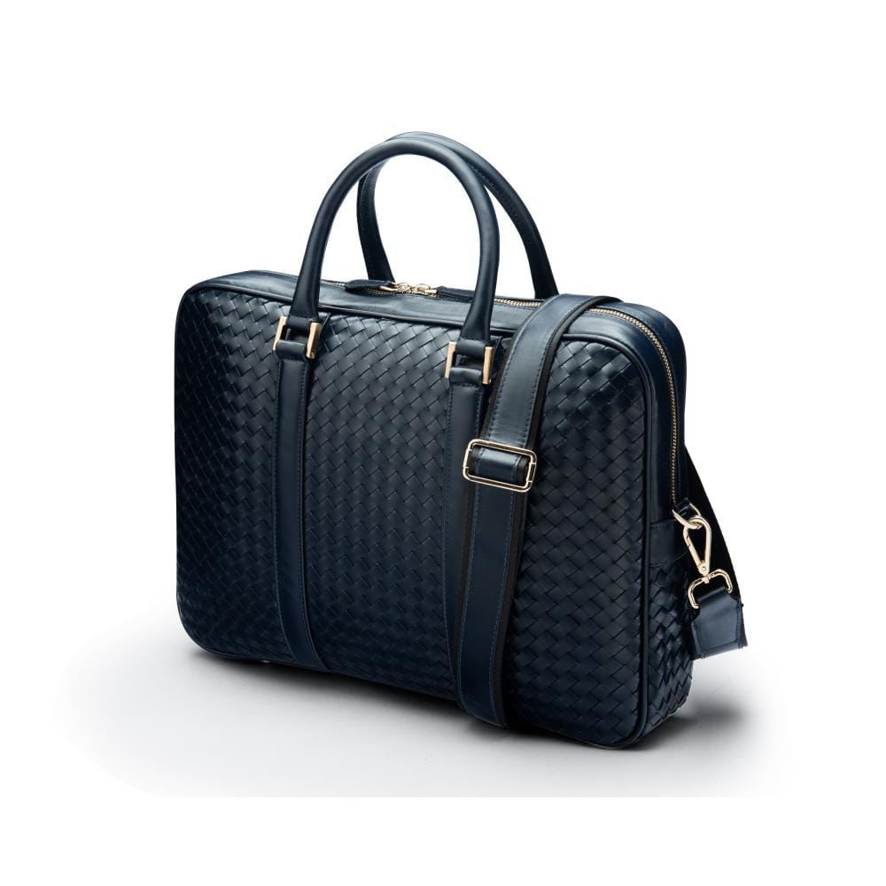 The Tressé leather laptop bag, navy woven, with shoulder strap