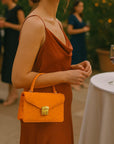 Real ostrich Maya top handle bag, orange, lifestyle