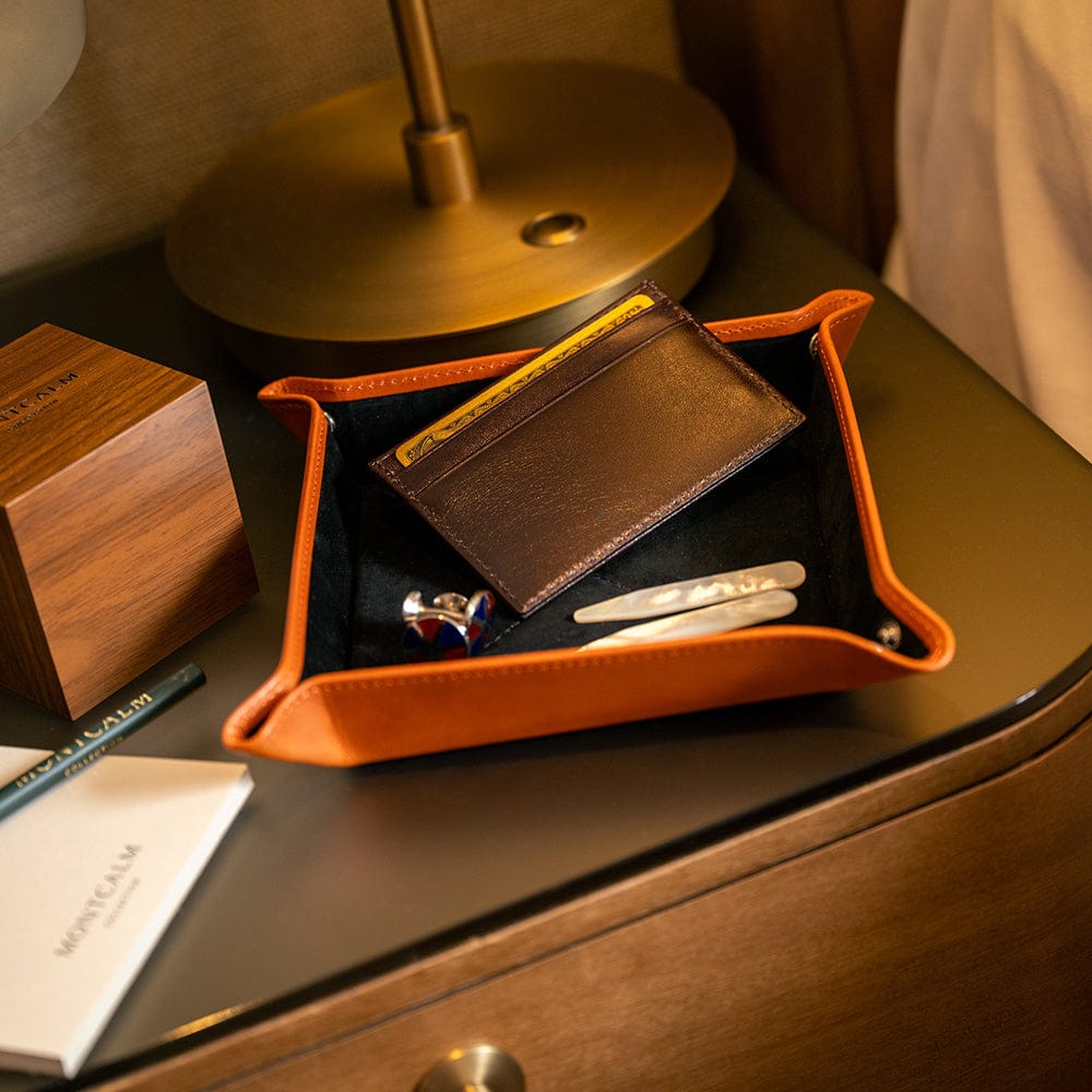 Leather valet tray, orange with black, lifestyle