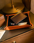 Leather valet tray, orange with black, lifestyle