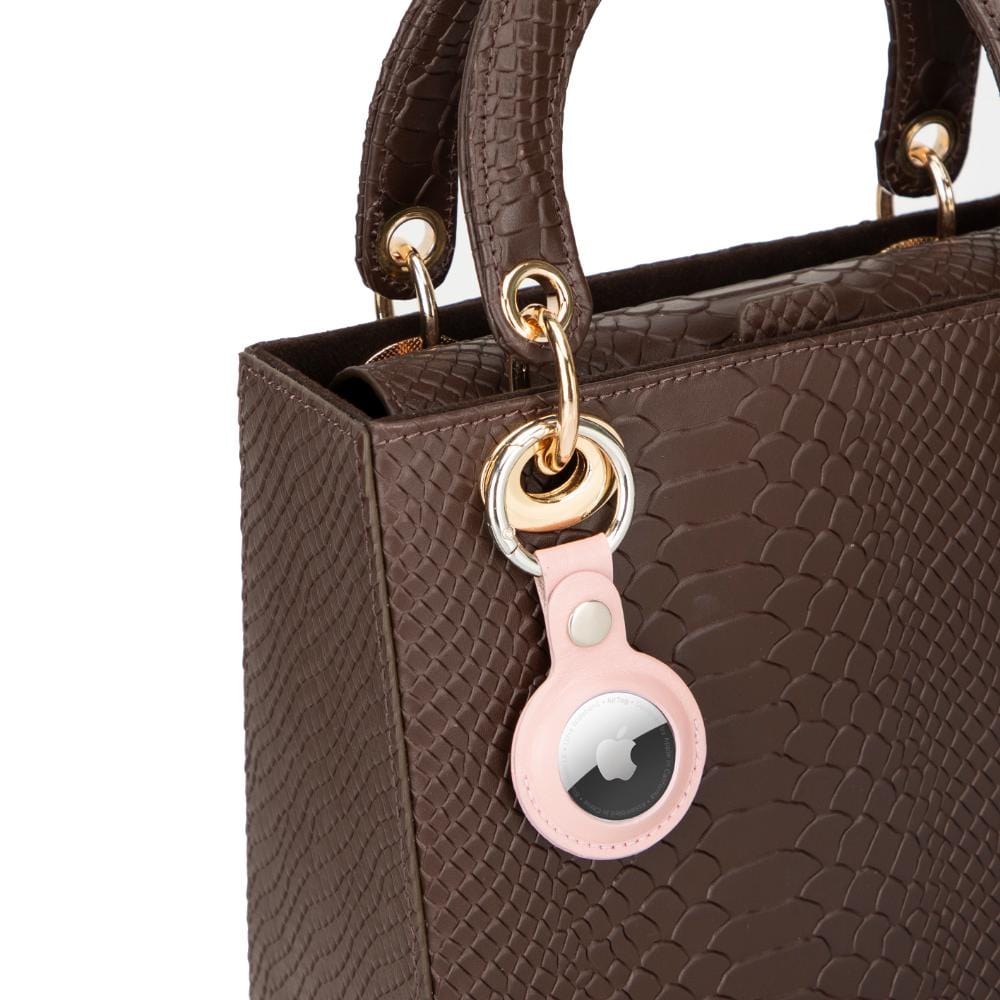 Leather air tag holder, pink, on a bag