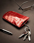 Leather key case with squeeze spring opening, red croc, lifestyle