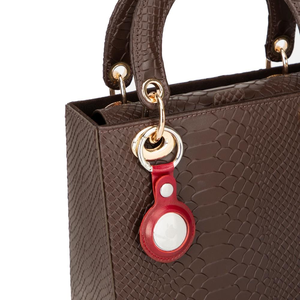 Leather air tag holder, red, on a bag