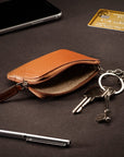 Small leather coin purse with key chain, tan, lifestyle