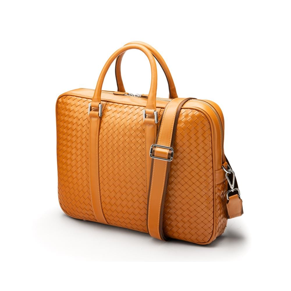 The Tressé leather laptop bag, tan woven, with shoulder strap