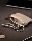 Miniature leather coin purse with key chain, taupe, lifestyle