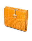 Leather purse with brass clasp, yellow croc, front view