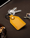 Rectangular leather key fob, yellow, lifestyle