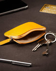 Small leather coin purse with key chain, yellow, lifestyle