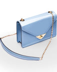 Small leather envelope chain bag, baby blue patent, side view