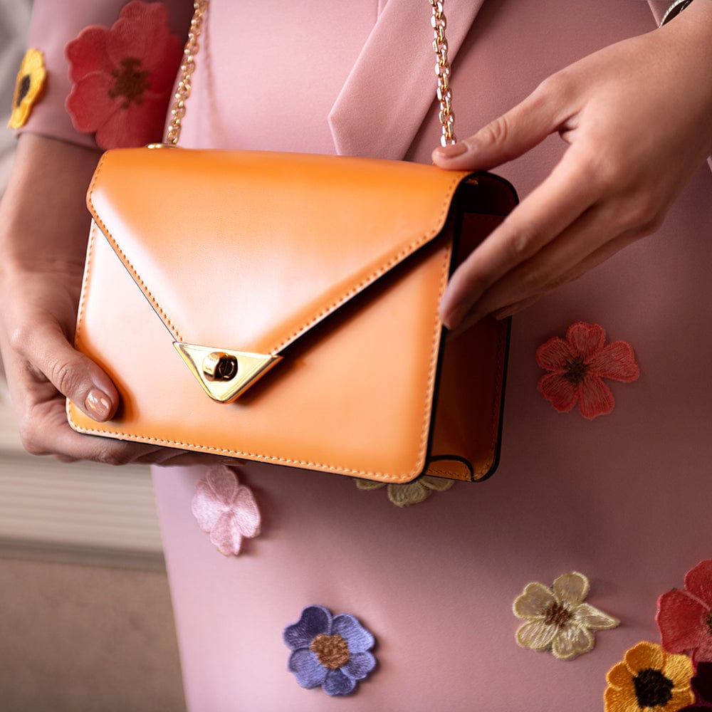 Mini leather chain envelope bag, orange, lifestyle view
