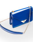 Small leather envelope chain bag, cobalt patent, side view