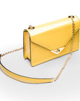 Small leather envelope chain bag, yellow patent, side view