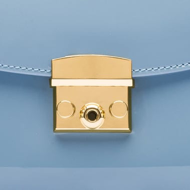 Small leather top handle bag, patent baby blue, lock closeup