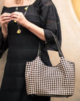 Black & EcruWoven leather shoulder bag, black and ecru check, lifestyle