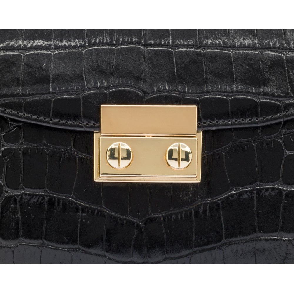 Small leather top handle bag, black croc, lock closeup