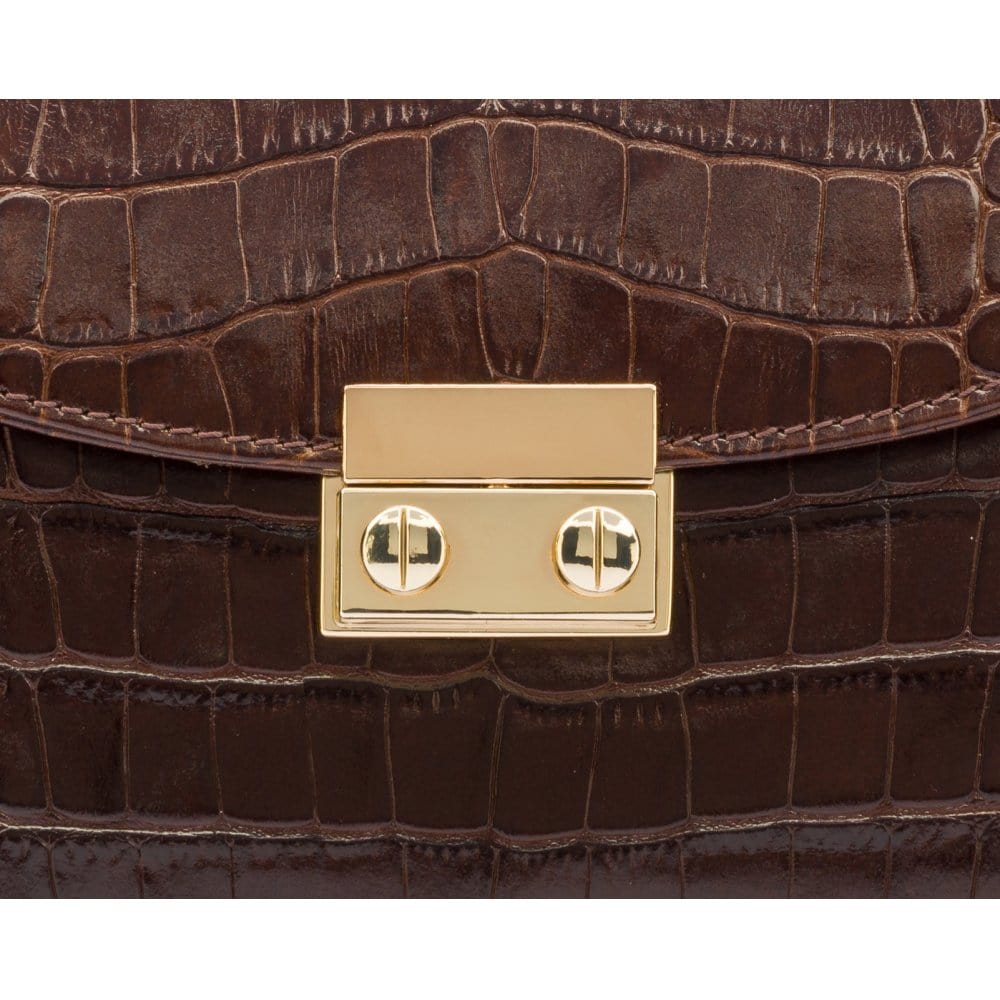 Small leather top handle bag, brown croc, lock close up