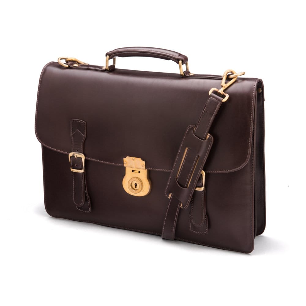 Leather satchel briefcase with straps and brass lock, brown, side