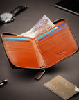 Men's leather wallet with zip around closure, brown with orange, lifestyle