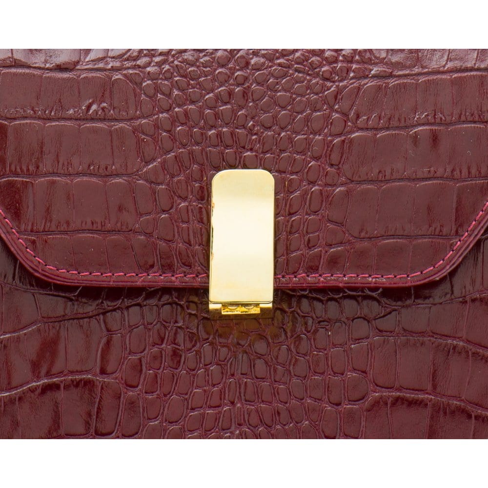 Leather top handle bag, burgundy croc, lock closeup