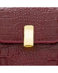 Leather top handle bag, burgundy croc, lock closeup