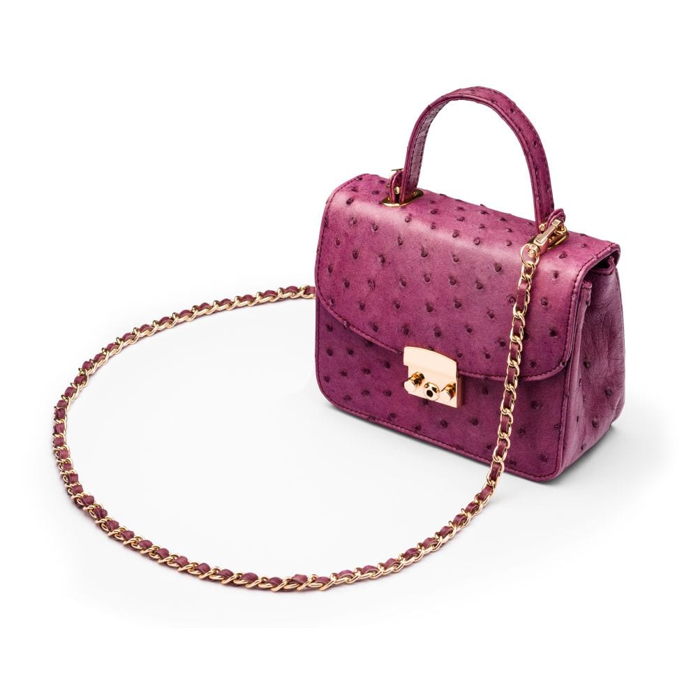 Small ostrich leather top handle bag, purple ostrich, side