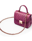 Small ostrich leather top handle bag, purple ostrich, side