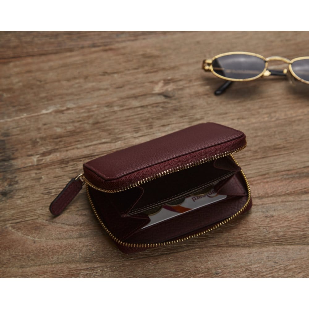 Small leather zip around coin purse, burgundy, lifestyle