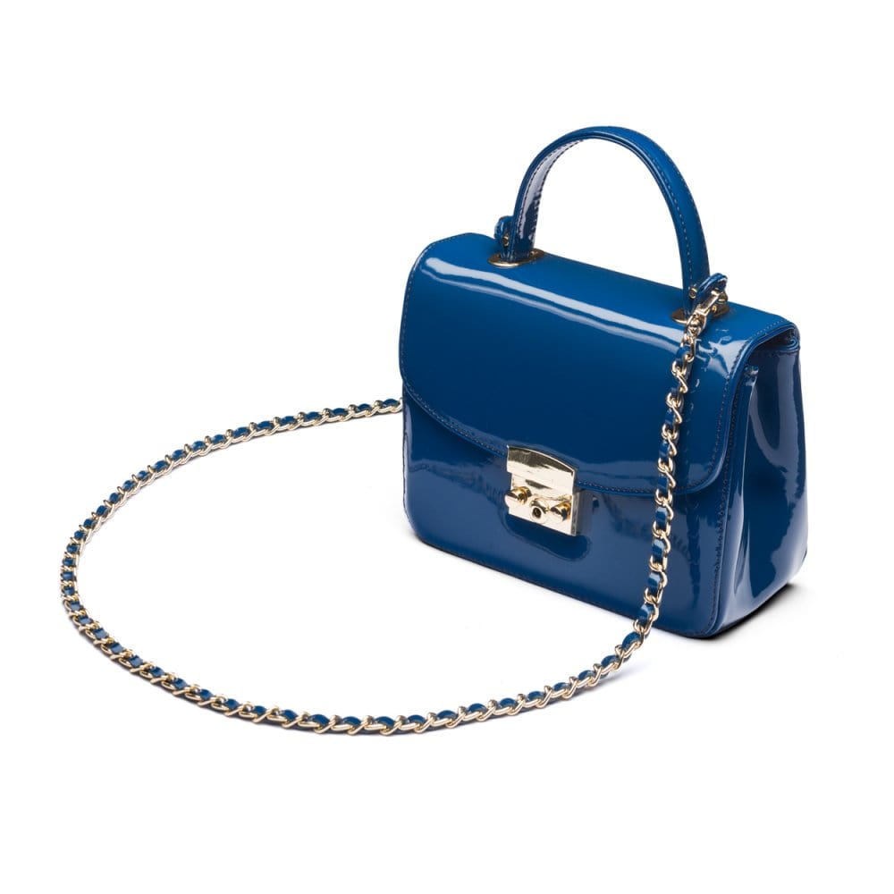 Small leather top handle bag, cobalt patent, side view