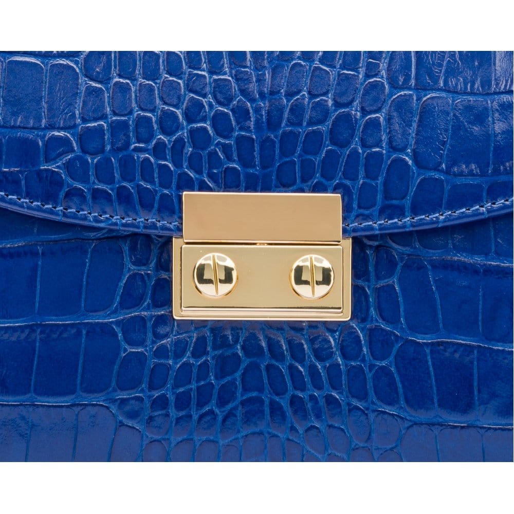 Small leather top handle bag, cobalt croc, lock close up