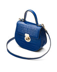 Leather rounded bottom top handle bag, cobalt croc, side