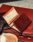 Tri-fold leather travel card wallet, dark tan, lifestyle