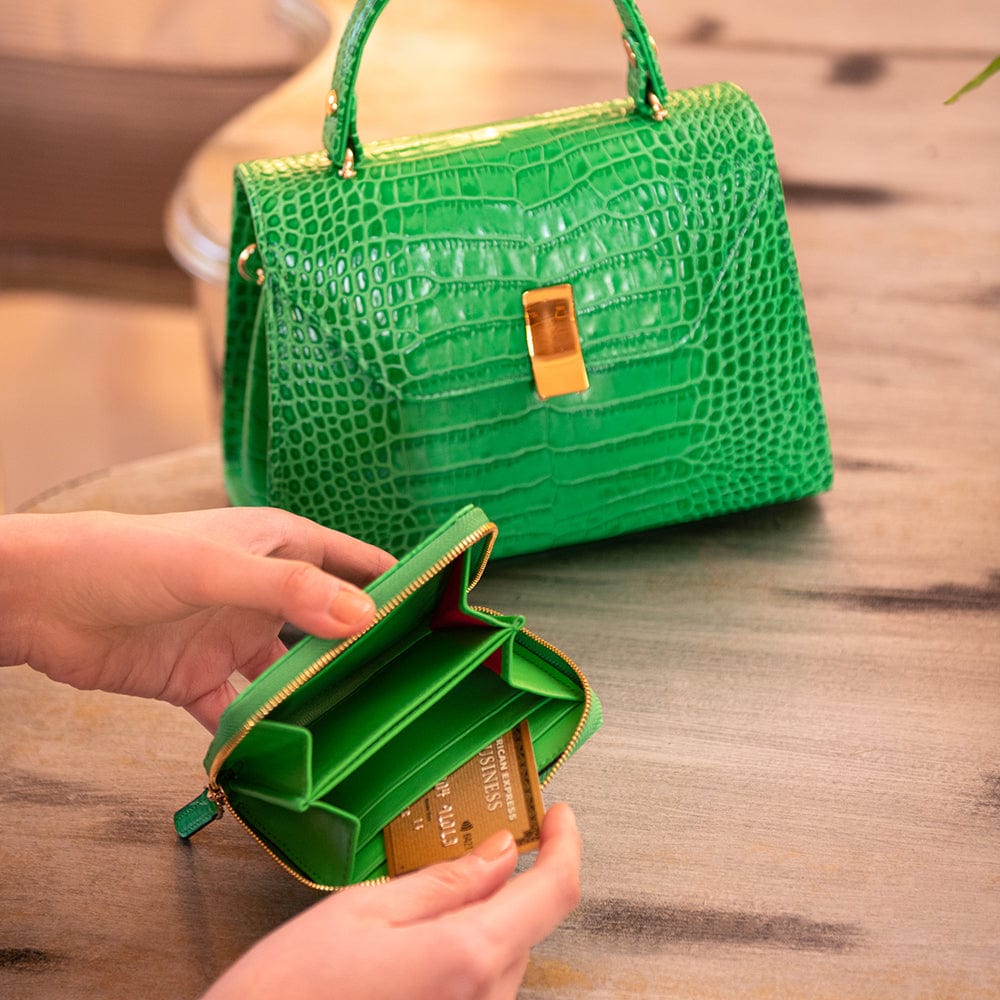 Small leather zip around accordion coin purse, emerald croc, lifestyle