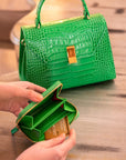 Small leather zip around accordion coin purse, emerald croc, lifestyle