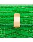 Leather top handle bag, emerald green croc, lock close up