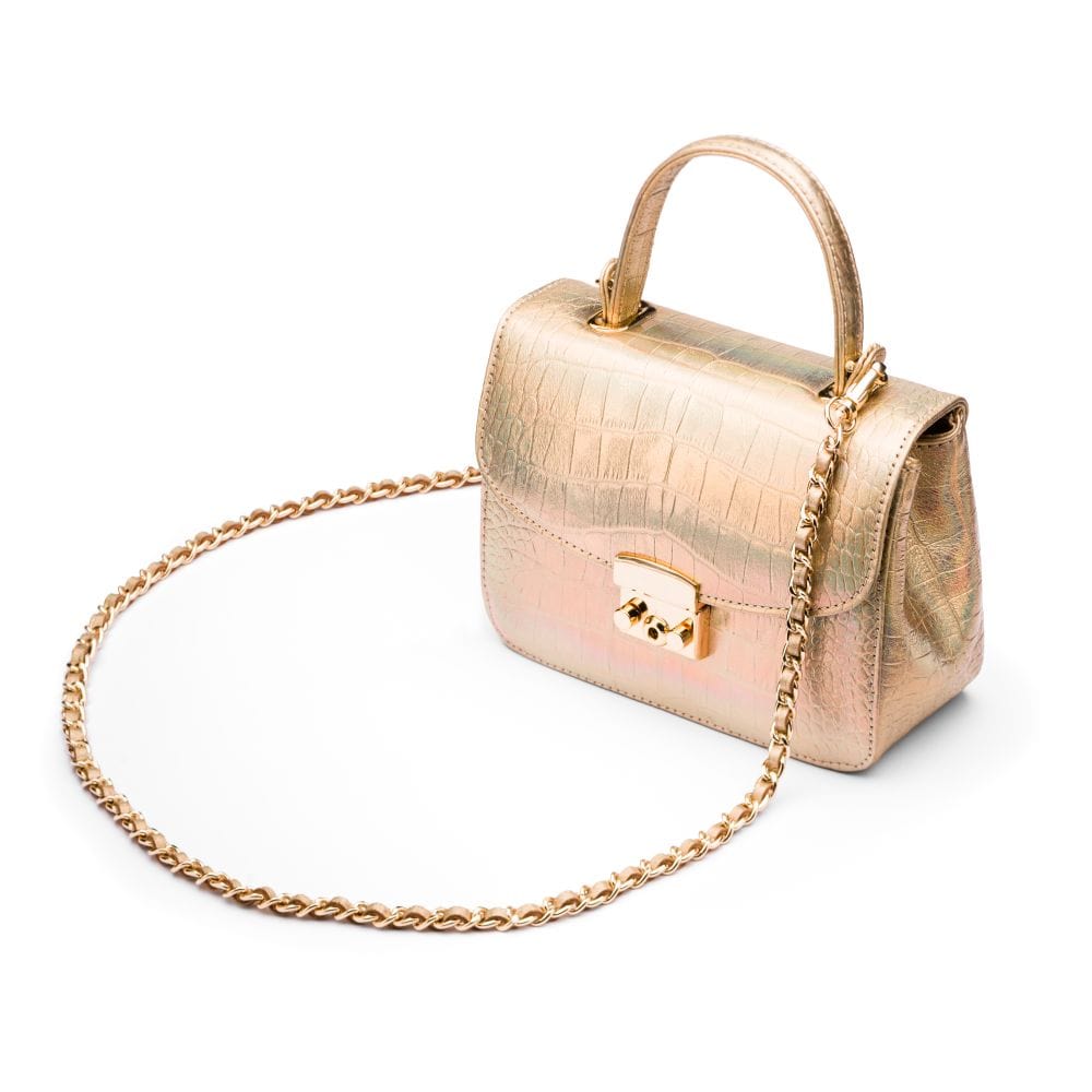 Small leather top handle bag, gold croc, side