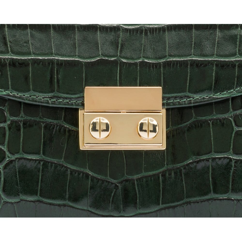 Small leather top handle bag, green croc, lock close up
