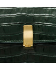 Leather top handle bag, green croc, closeup of the clasp