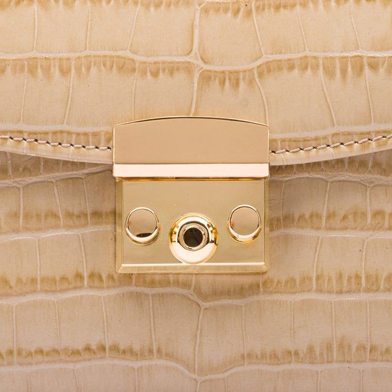 Small leather top handle bag, ivory croc, lock close up