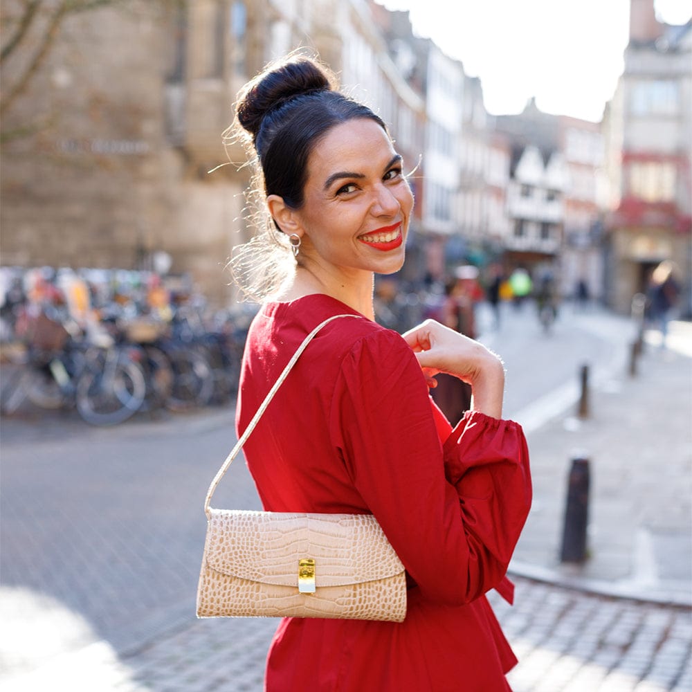 Leather clutch bag, ivory croc, lifestyle view