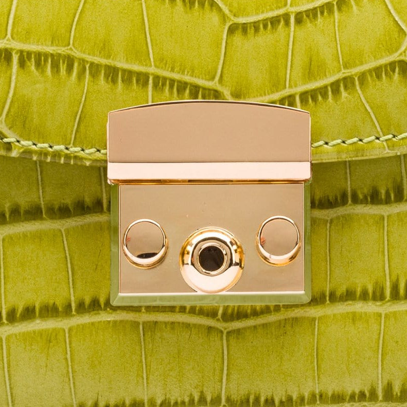 Small leather top handle bag, lime green croc, lock close up