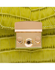 Small leather top handle bag, lime green croc, lock close up