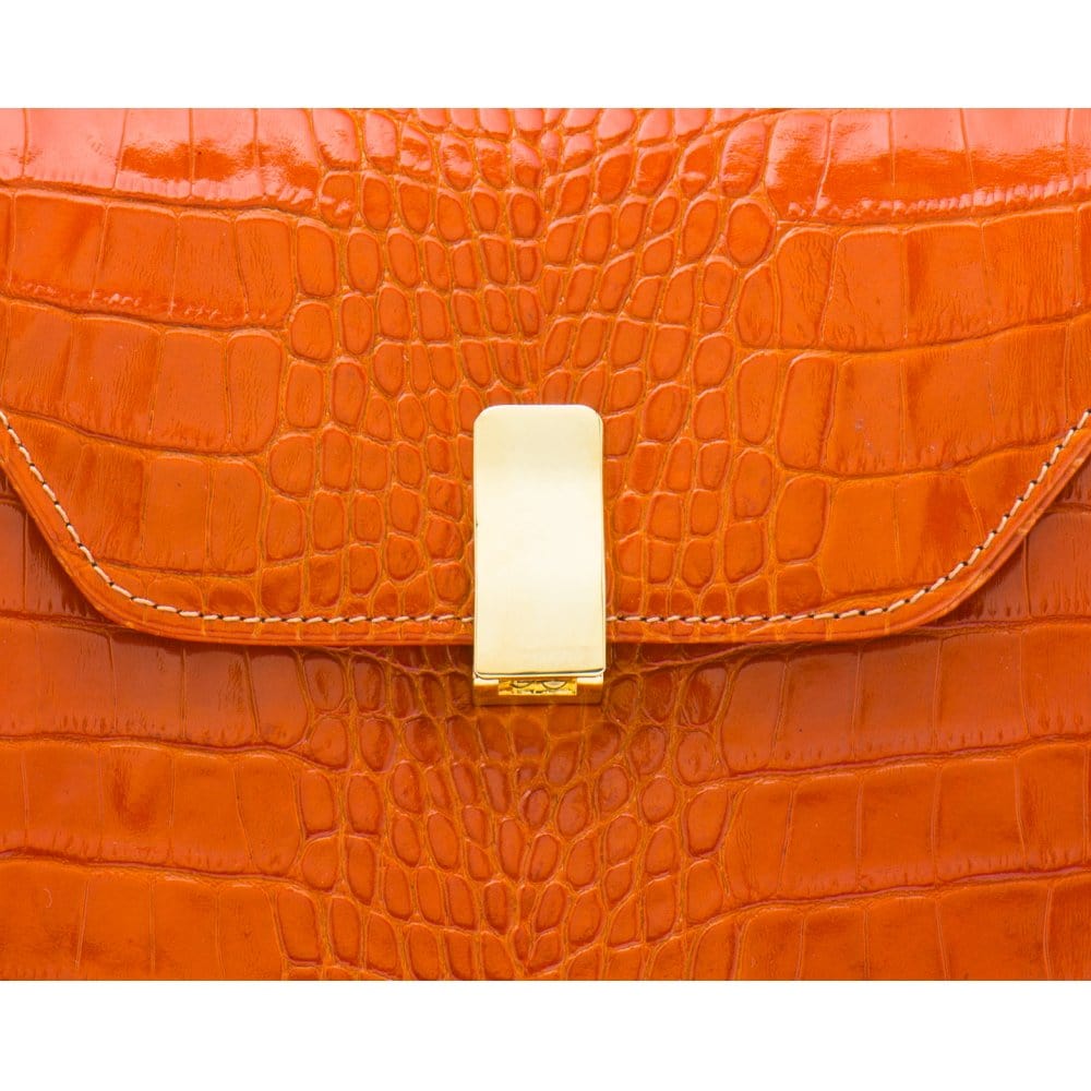 Leather top handle bag, orange croc, lock close up