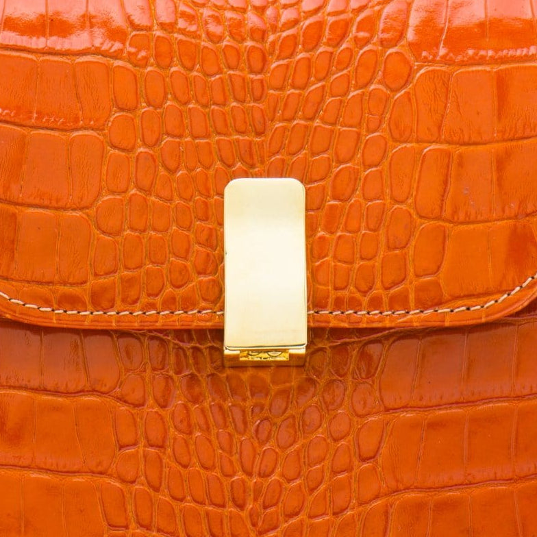 Leather top handle bag, orange croc, lock close up